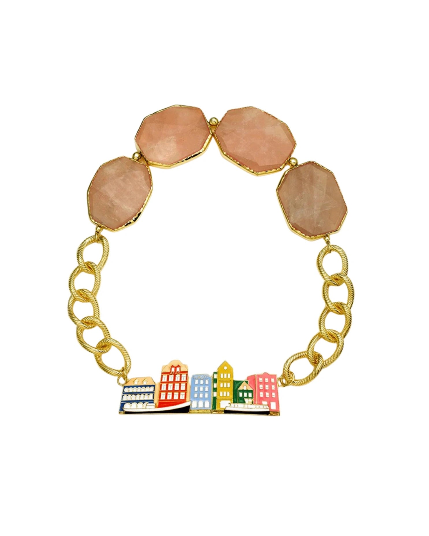 A gold chain bracelet featuring four peach-pink faceted gemstone beads at the top and a colorful cityscape charm with miniature buildings in red, yellow, blue, green, and white at the bottom, set against a plain white background.